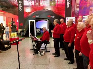 Dublin Welsh choir performing outside Dome Cymru